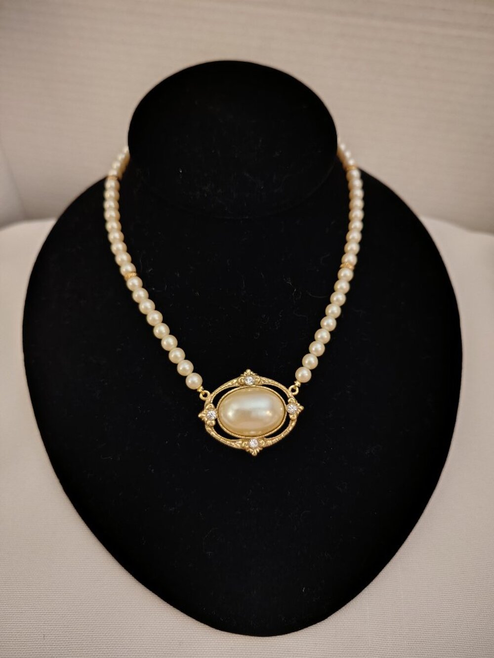 Faux Pearl Necklace with Large Faux Pearl Cabochon and Rhinestone Accent.